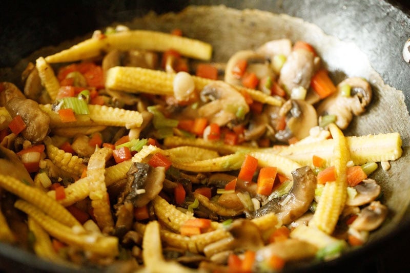 stir-frying mushroom and veggie mixture.