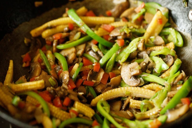 sliced green bell pepper added to mixture in pan.
