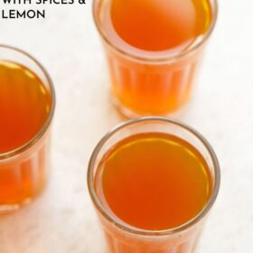 three glasses filled with sulaimani chai on a cream background with text layovers.
