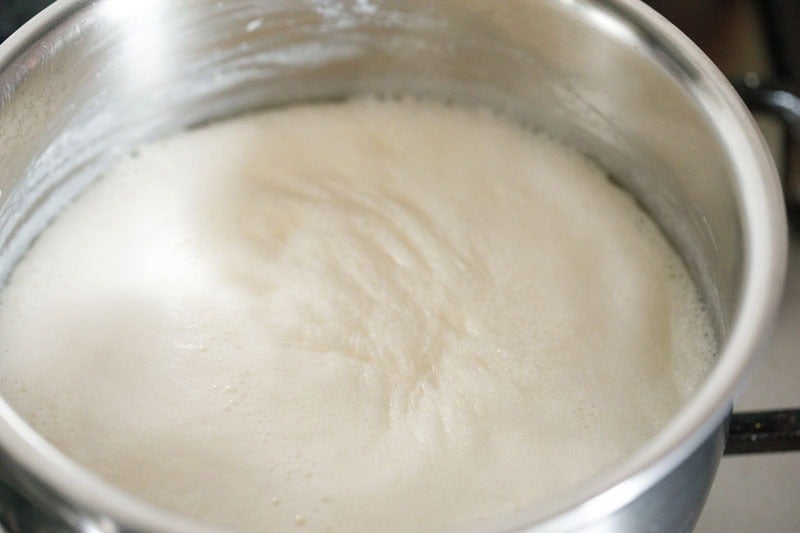boiling milk in saucepan for making irani tea. 