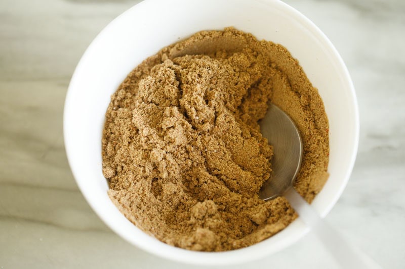 ground roasted spices added to a bowl.