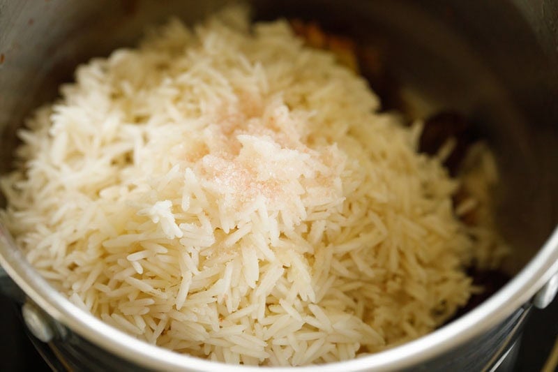 drained basmati rice and salt added to gucchi mushroom. 