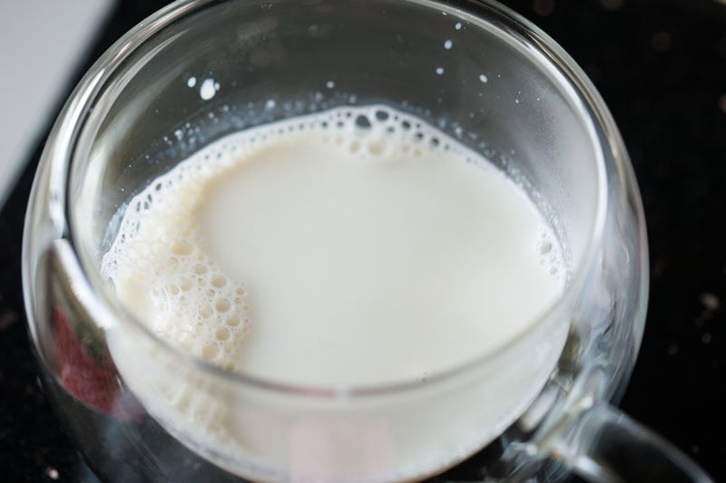 thickened hot milk added in a cup for making irani tea. 