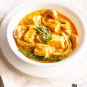 paneer sabji in a white bowl on off-white colored folded napkin.