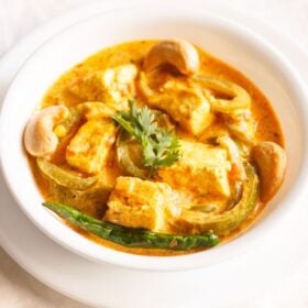 paneer sabji in a white bowl with text layovers.