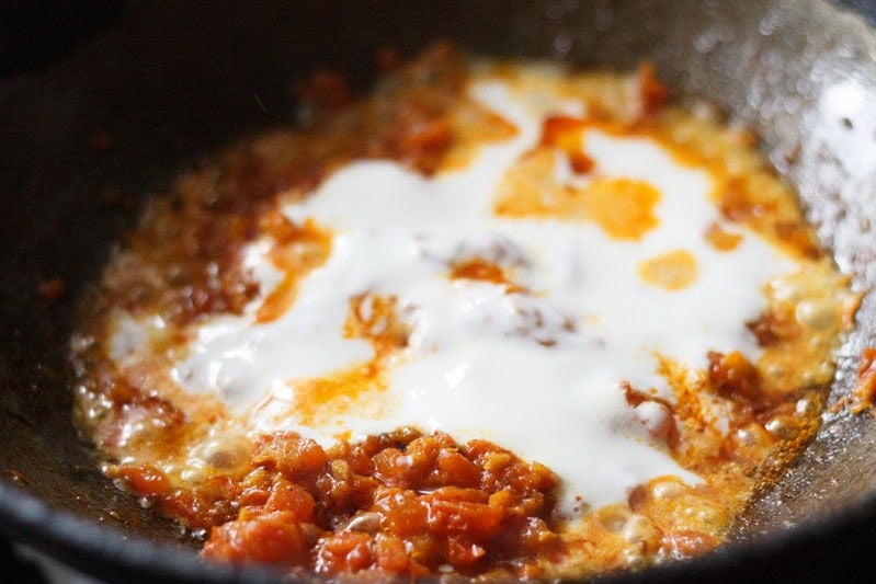 curd added to onion-tomato masala mixture.