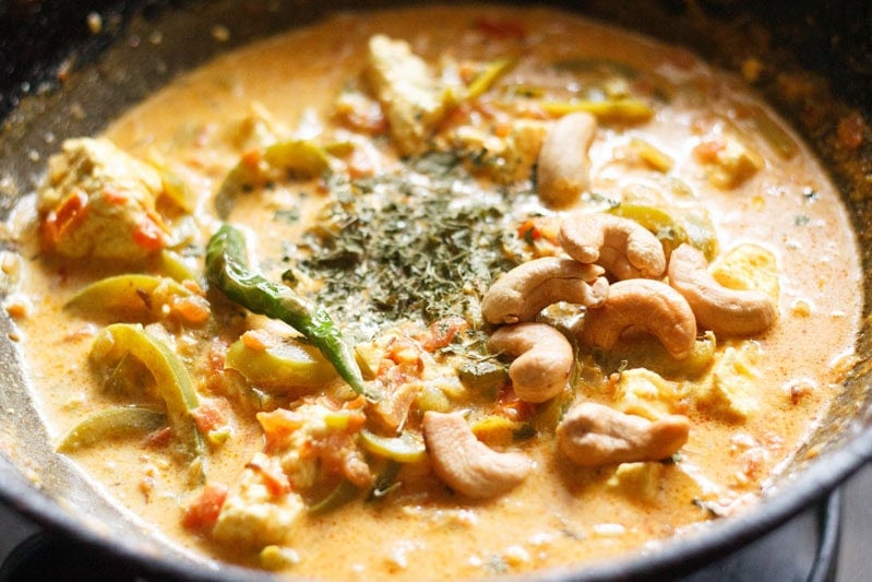 fried cashews, fried green chilies and crushed kasuri methi added to paneer sabji.