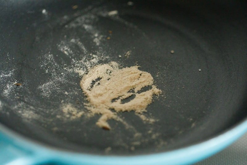 roasting asafoetida in hot pan for making chaat masala recipe.