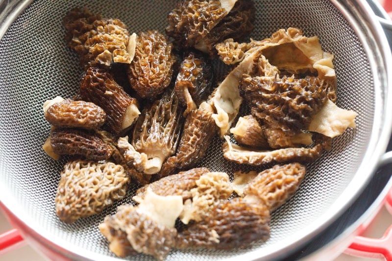 drained and chopped morel mushrooms in a strainer. 