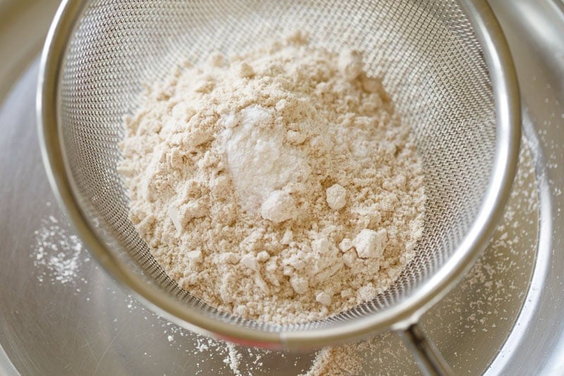 whole wheat flour, baking powder and salt added to a sieve.