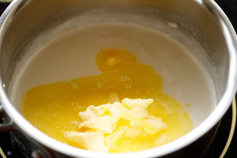 butter floating on hot milk and partly melted.