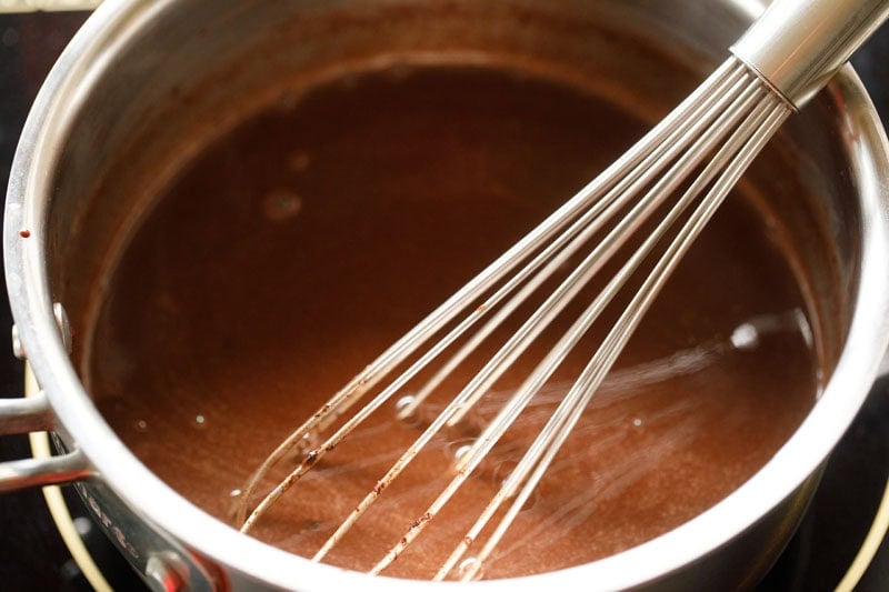 mixing chocolate chips with a whisk in the wet mixture.