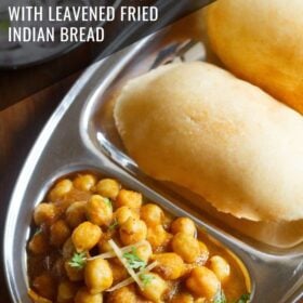 chole bhature on a plate with sections for chana curry and fried bread with text layovers.