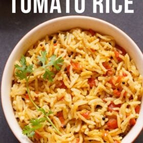 Tomato Rice with a coriander leaf sprig served in a cream bowl on a black board with text layovers.