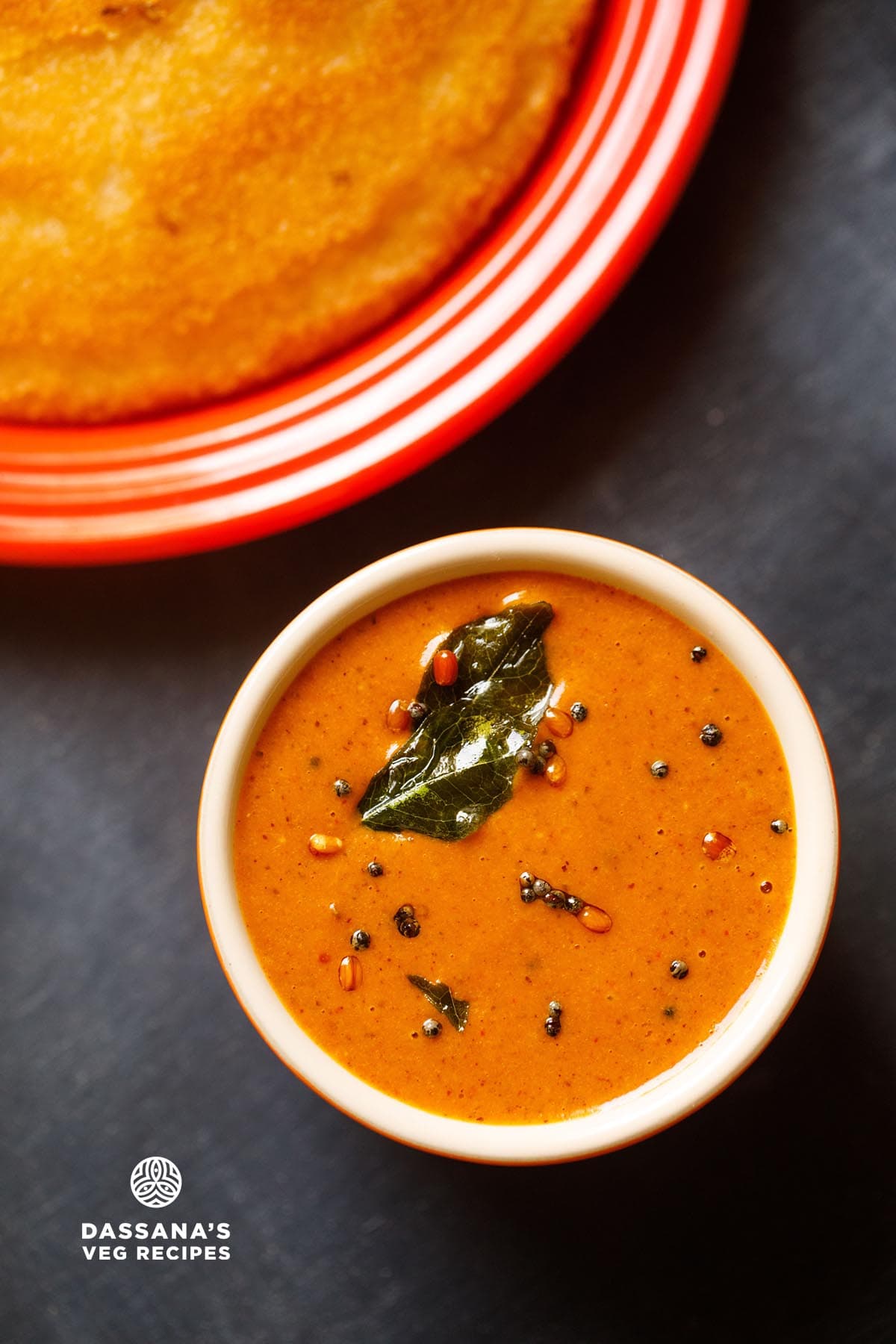 over head shot of allam chutney (Andhra ginger chutney) in a small serving bowl topped with tempering mixture.