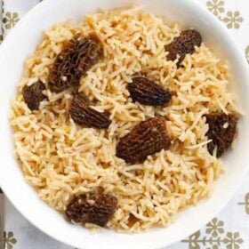 gucchi pulao in a white bowl.