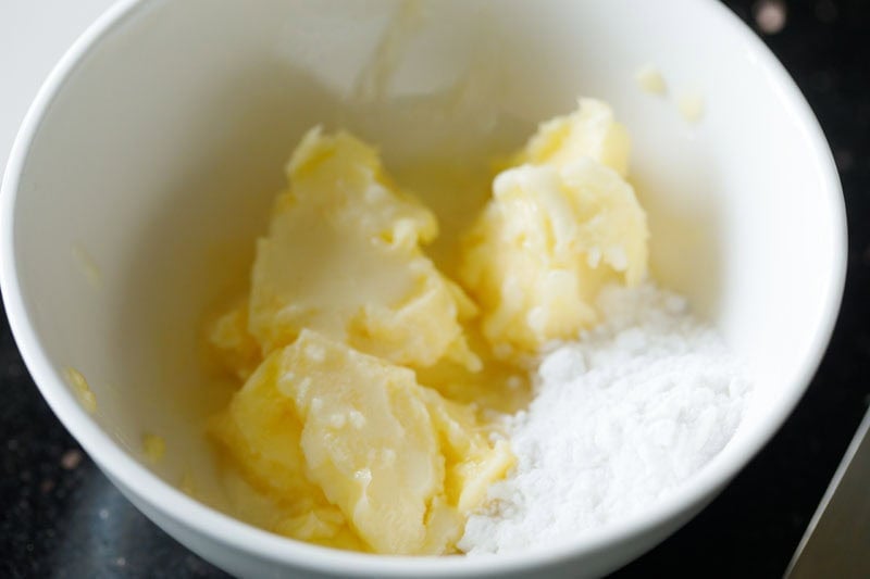 Butter, cream and powdered sugar in a bowl.