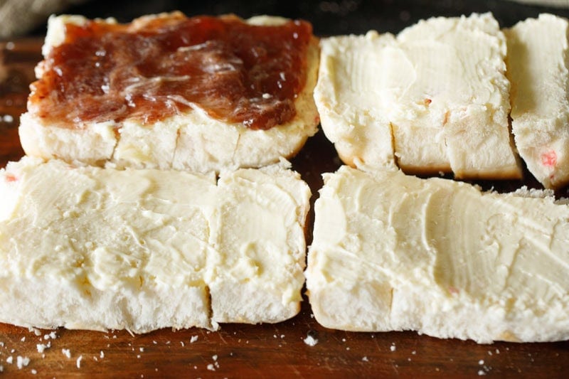 sliced bun with jam and butter.