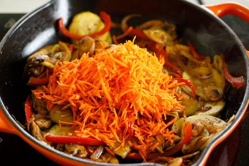 Colorful sautéed vegetables with shredded carrots.
