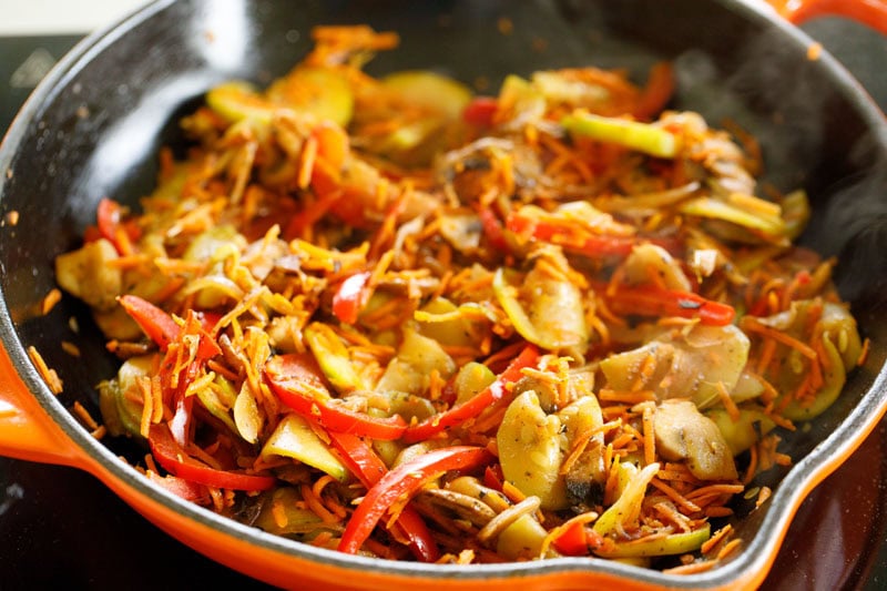 Colorful sautéed vegetables in skillet.