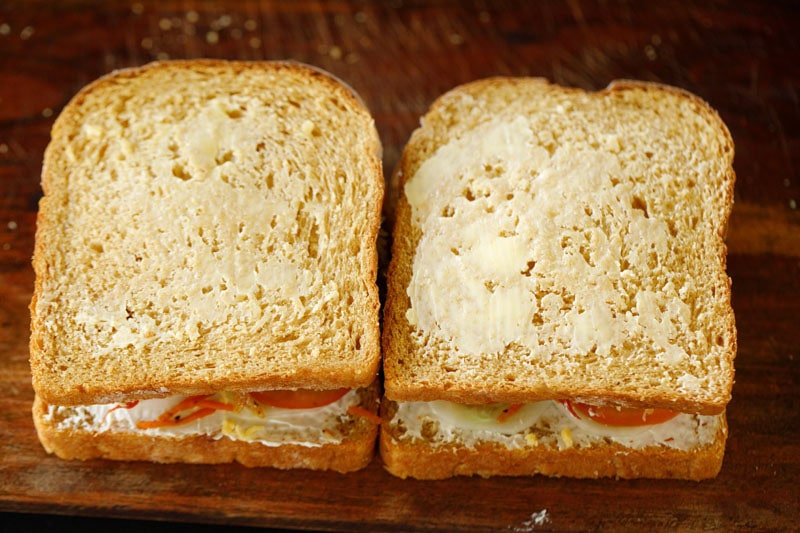Butter spread on top prepared vegetable sandwich.