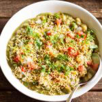 masala puri served in a white bowl with a spoon.