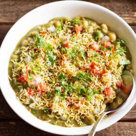 masala puri served in a white bowl with a spoon.