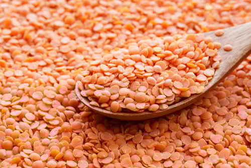 closeup shot of hulled and split pink lentils or masoor dal.