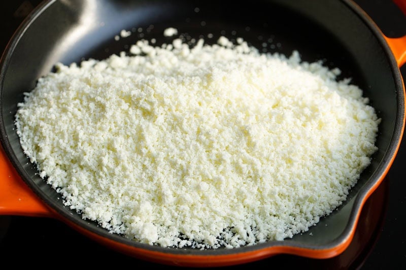 Finely grated mawa in skillet.