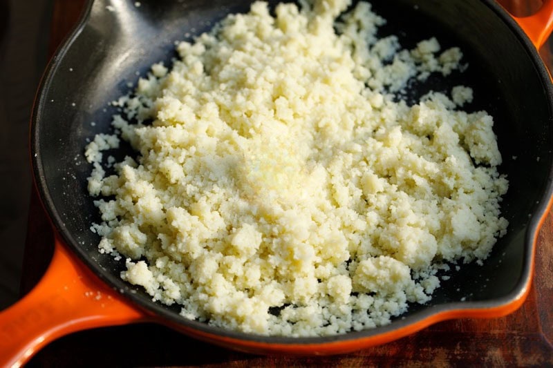 Khoya mixed with sugar in skillet.