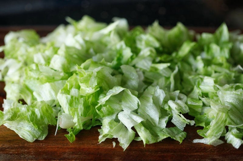 chopped lettuce on chopping board.