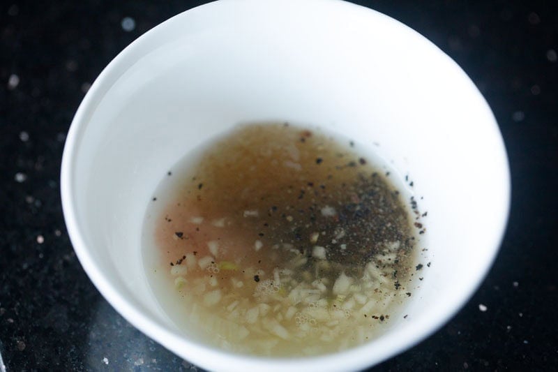 spices, garlic, lemon juice, seasonings in bowl.