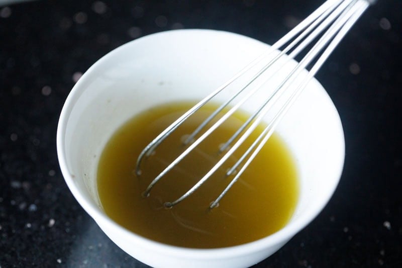 lemon vinaigrette mixed with a wired whisk.