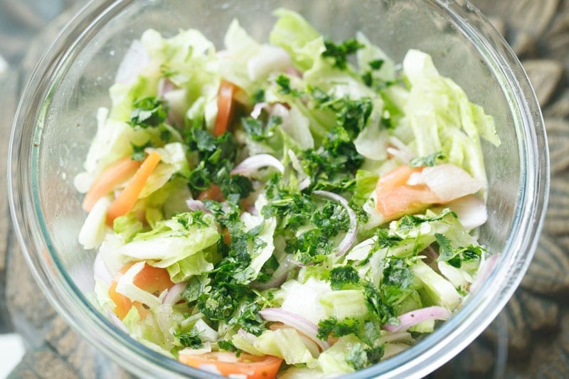 chopped cilantro (coriander leaves) added on top of the green salad.