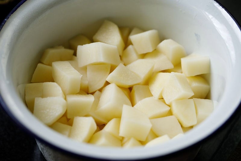 Cubed potatoes in a white bowl.