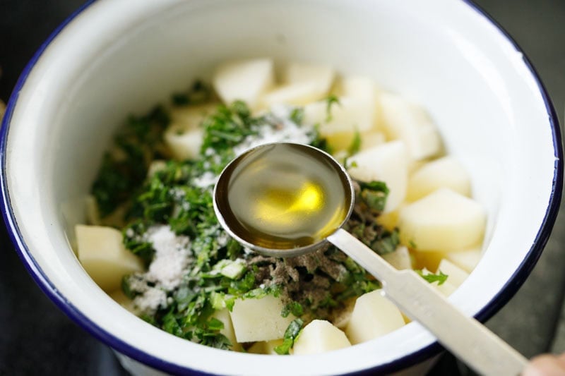 Chopped potatoes with herbs in pot