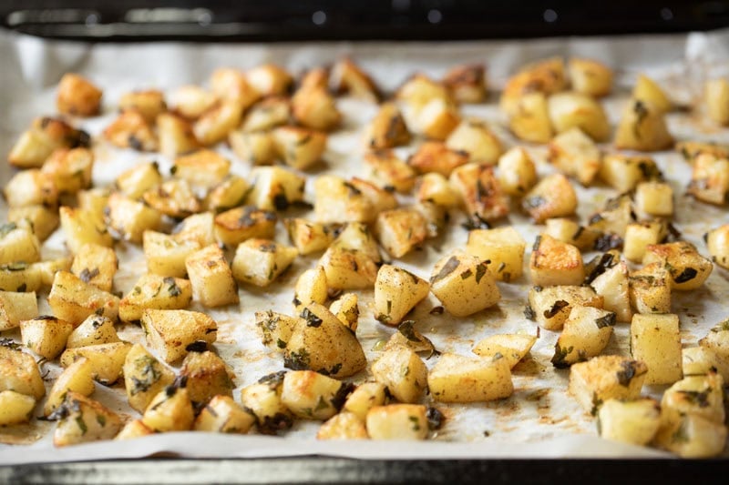 baked potatoes on the parchment lined baking tray.