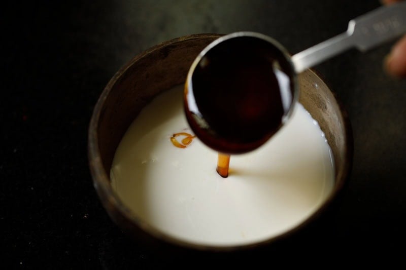 Pouring honey into a the bowl to make panchamrit recipe.