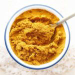 Bowl of homemade sabji masala with a spoon