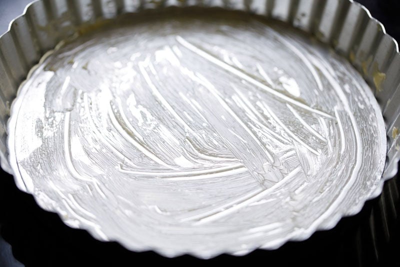 Greased pie pan ready for to make banoffee pie.