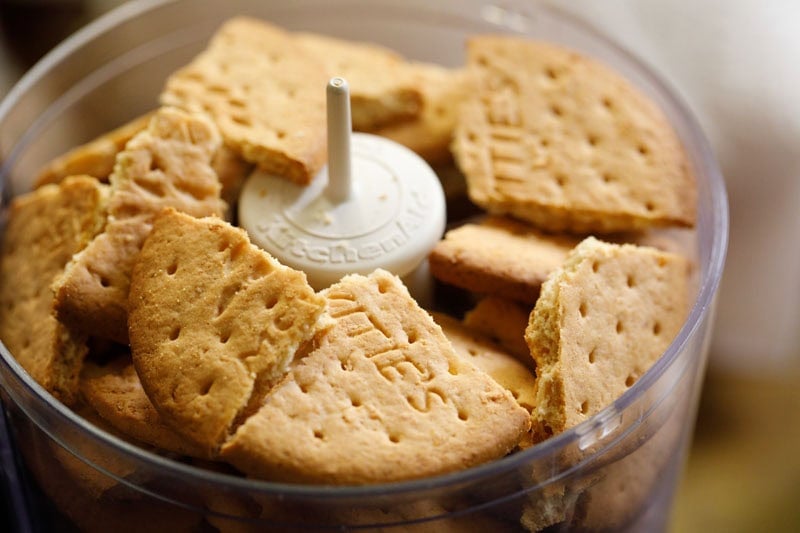 Biscuit chunks in food processor container.