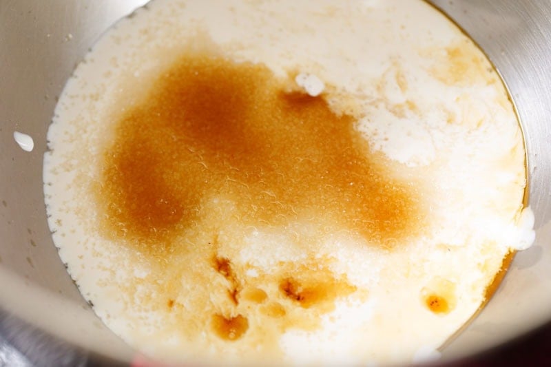 Whipping cream with vanilla and sugar in a bowl.