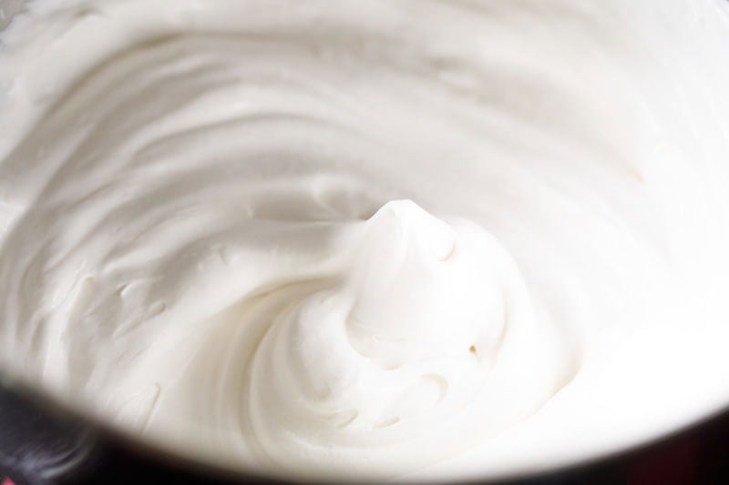 Fluffy whipped cream with soft peaks.