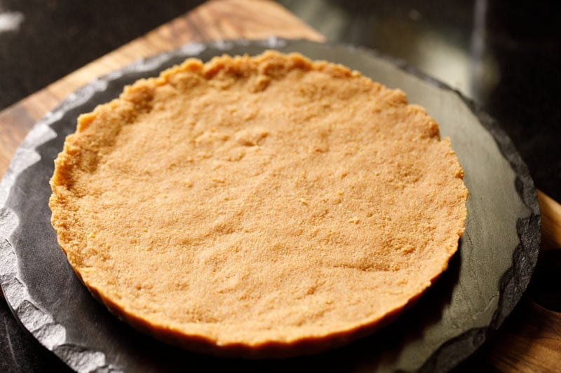 Unbaked biscuit crust on serving platter.