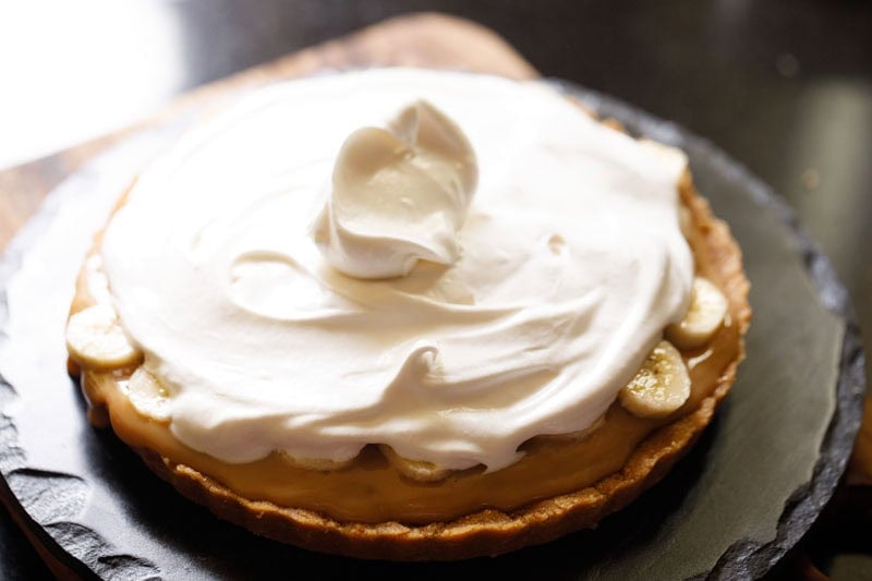 Whipped cream on top of the sliced bananas.