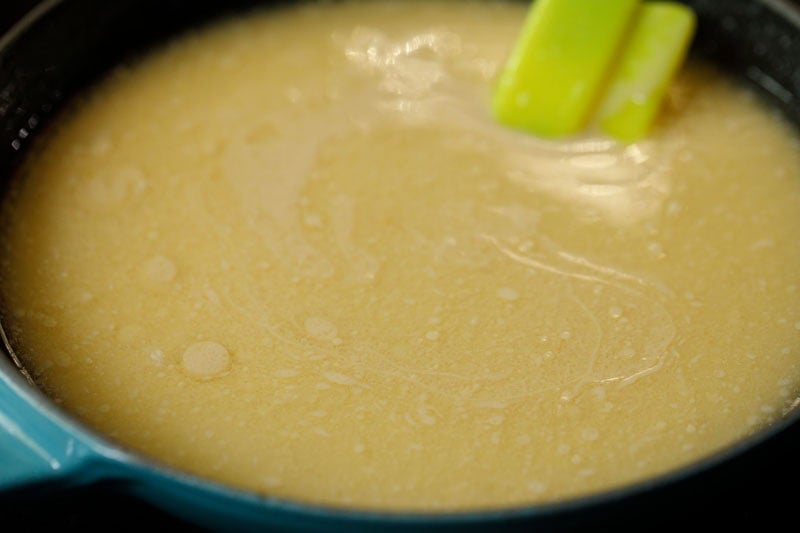 Condensed milk and milk evenly mixed with melted butter in skillet.