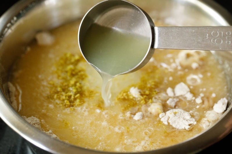 Pouring lemon juice into the batter mixture.