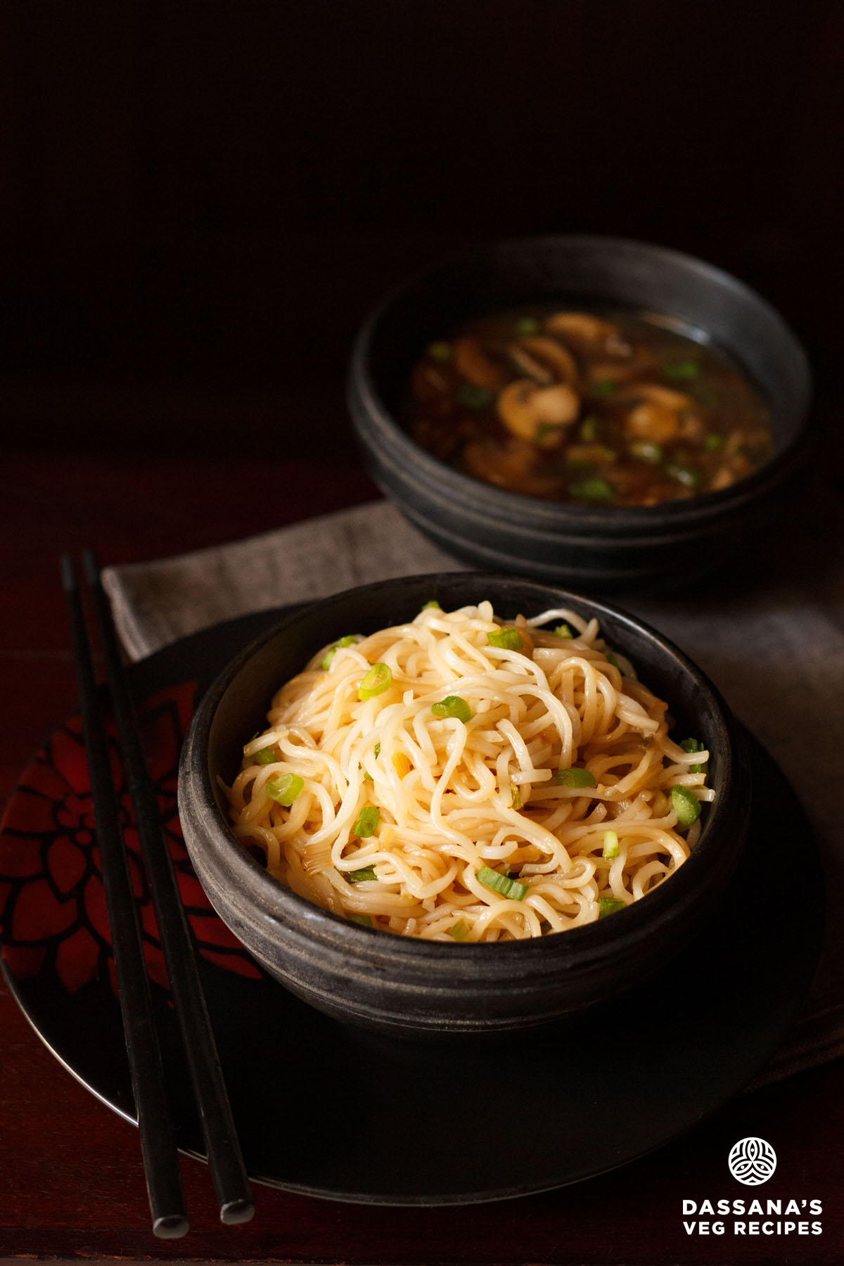 Chilli garlic noodles served in a black bowl.
