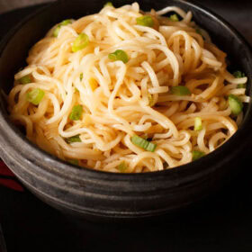Steaming bowl of chilli garlic noodles.