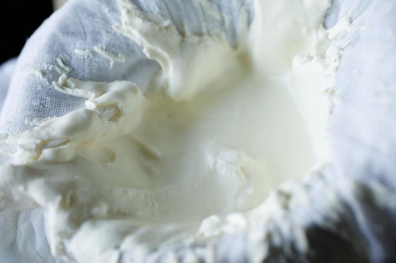 Thick cream greek yogurt or hung curd in cheese cloth.